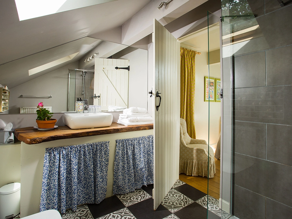 Pretty cottage style bathroom with shower in Garden Lodge, Lodge Cottages, Yorkshire.